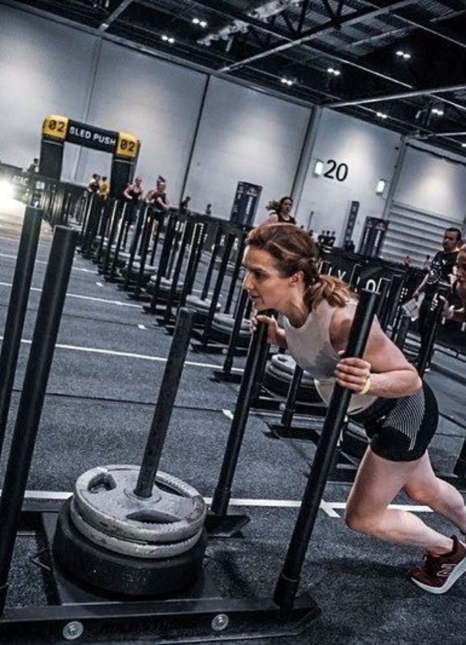 woman on sled push at hyrox