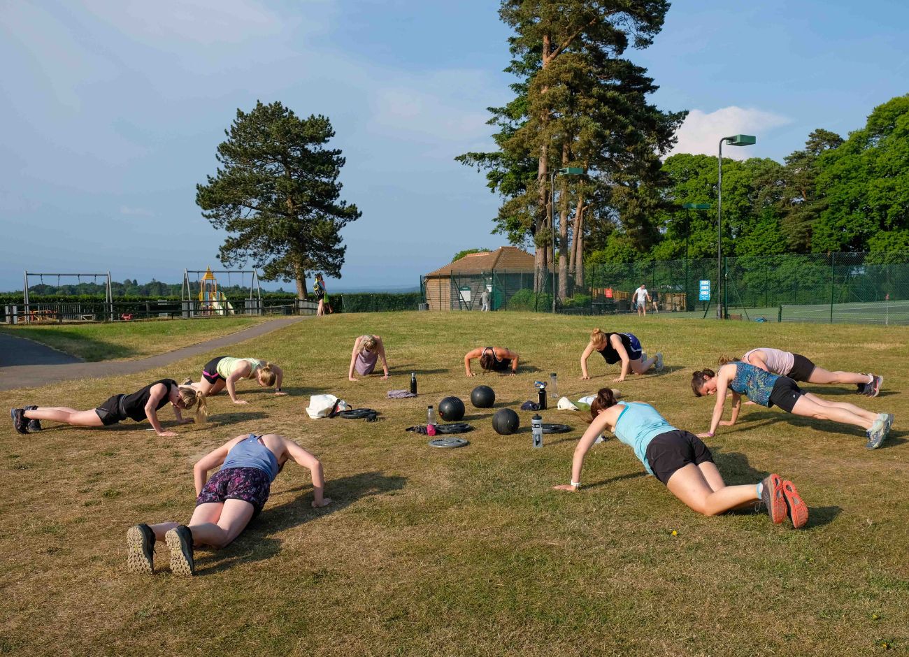 Bootcamp group exercising on ground