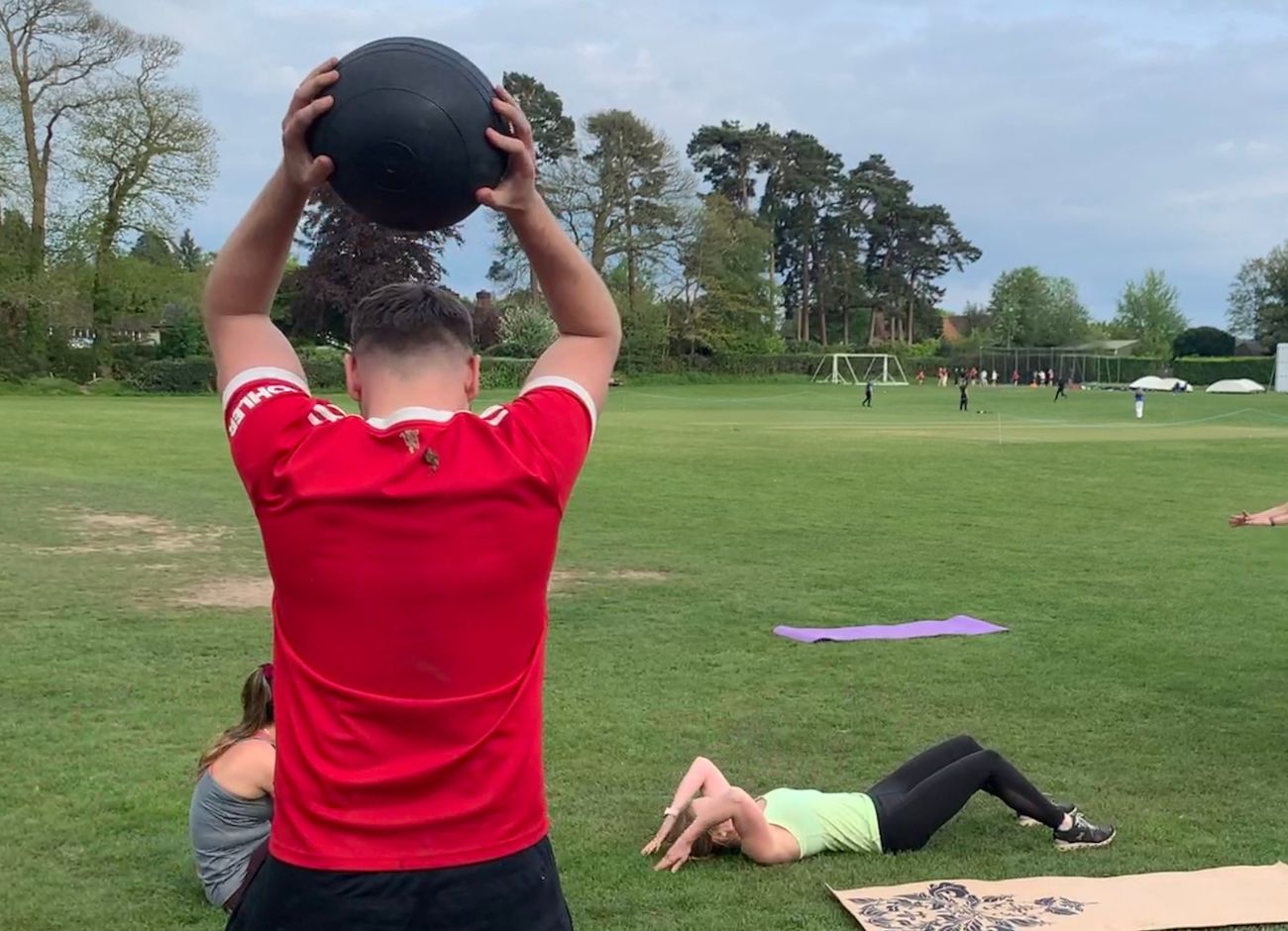 strong man exercising with weighted ball at bootcamp